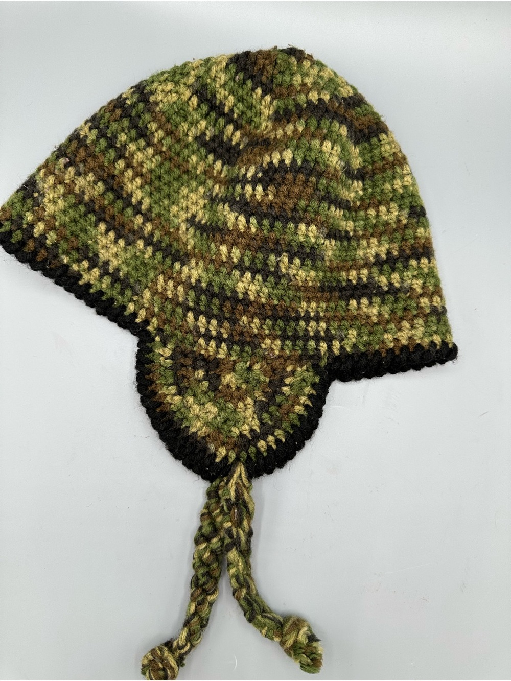 Handmade crochet camouflage earflap beanie featuring braided ties